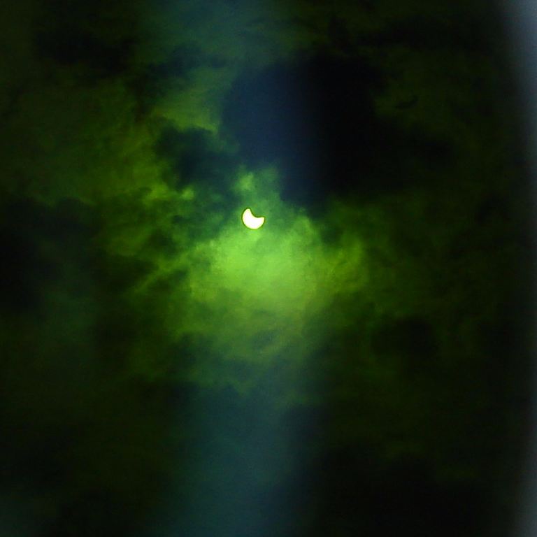 A green and eclipsed sun