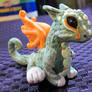 little green and orange dragon