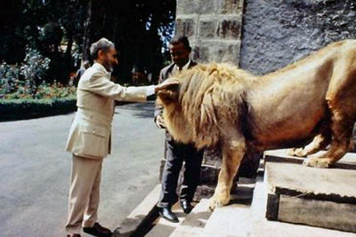 Haile Selassie petting a lion