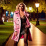 Young crossdresser in a metallic pink trench coat
