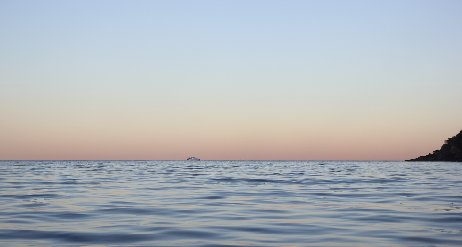 Boat crossing horizon