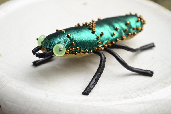 Green beetle fabric sculpture