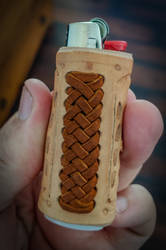 Braided leather lighter sleeve.