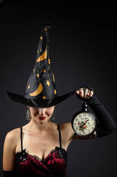 WITCH HOLDING THE CLOCK