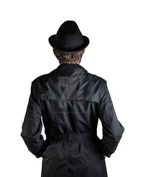 ISOLATED BACK OF A MAN IN BLACK COAT AND HAT STOCK