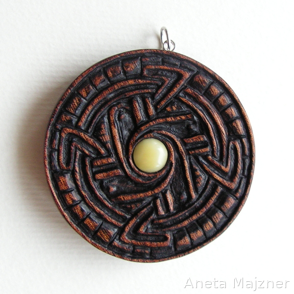 Carved pendant - amber and wood