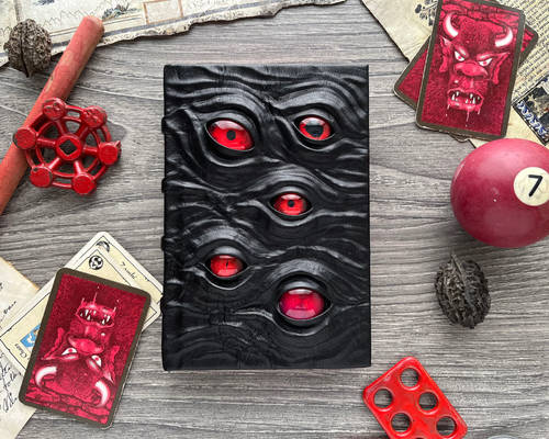 Little black leather book with red eyes