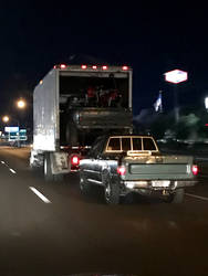 Motorcycles in a truck in a tuck pulling a truck