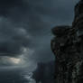 An eerie aerie up on a cliff face, a dark and stormy sea below