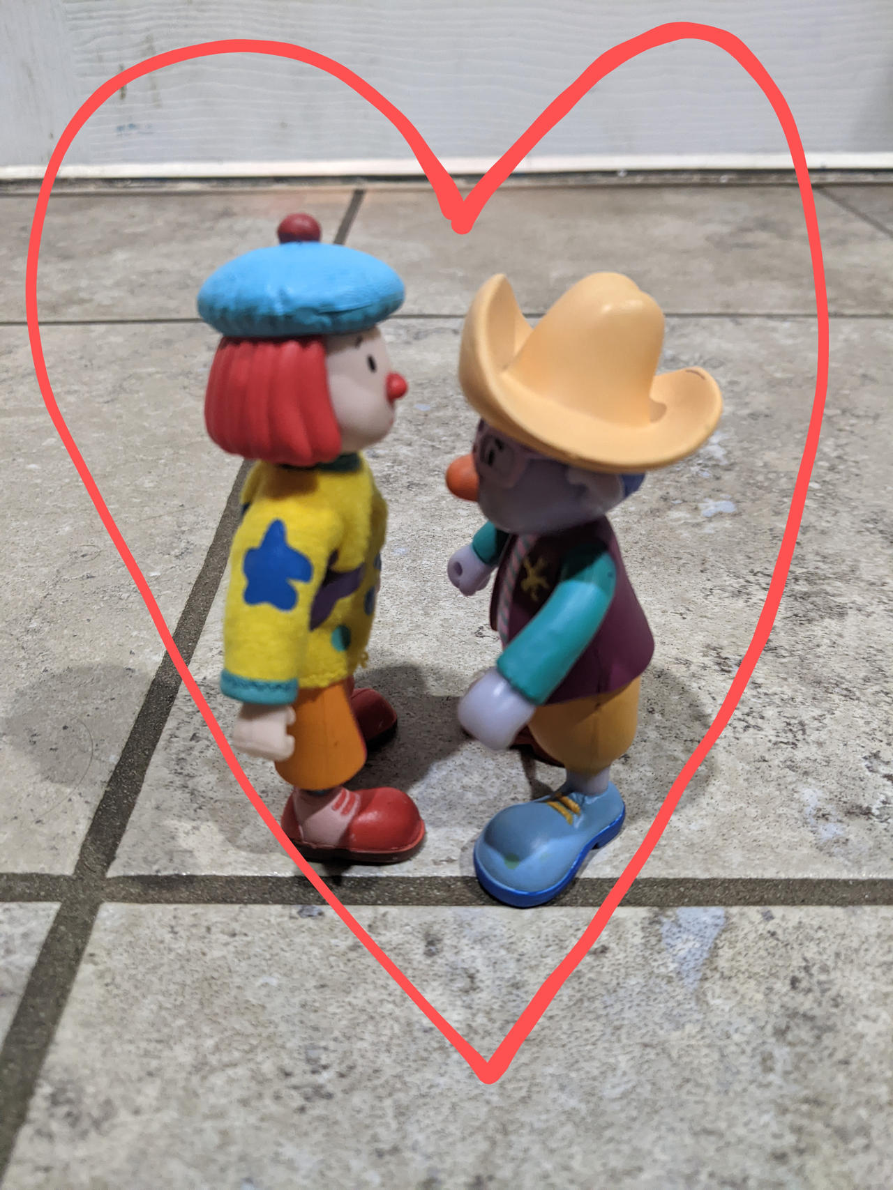 JoJo and Skeebo figures in a heart