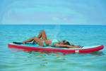 girl resting on a surf board by glparker