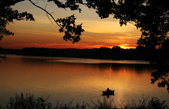 sunset at lake with an angler