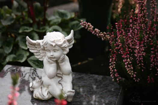 little angel statue on a grave