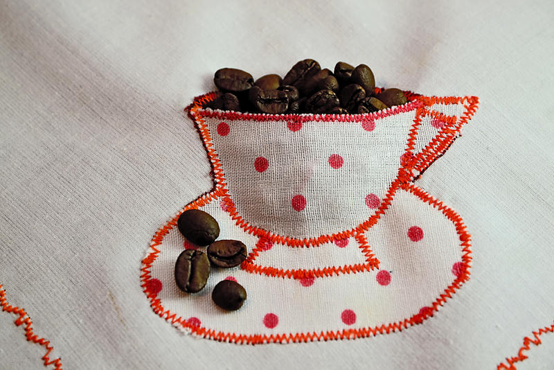 Cup with coffee beans by gabiano