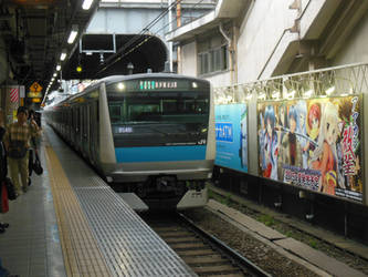 E233.136 and Ayakashi Sange Billboard at Akiba Stn