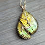 Tree pendant with a broken labradorite gemstone.