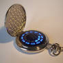 Silver pocket watch with blue LED display