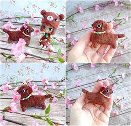 Tiny teddy bear brown retro style dachshund puppy