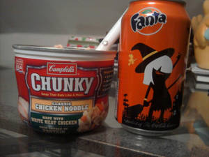 Chicken noodle soup w. a soda on the side.