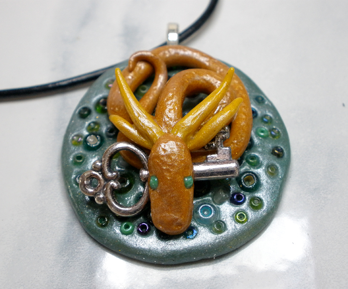 gold dragon guarding key polymer clay necklace