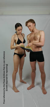 Male and Female Couple Looking at Book Pose