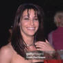 Headshot-of-american-actor-gina-gershon-touching-h