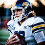 College football player with longish hair and pads