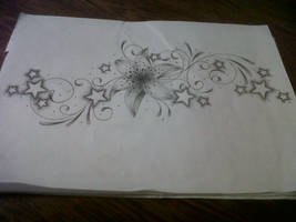 lily tattoo design with swirls and stars