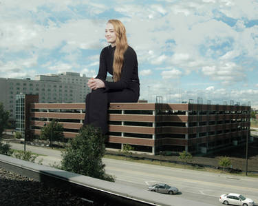 Sophie Turner sitting on a parking structure