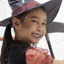 Happy child girl in witch costume to