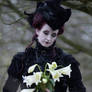 Stock - Gothic lady lilies look down portrait