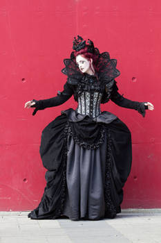 Stock - Gothic woman vampire red wall pose 1