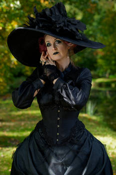 Stock - Gothic lady big hat hand to face pose