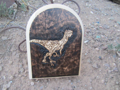 Utahraptor burned into wood