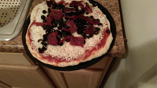 cheese pizza with olives and Jack Links teriyaki