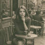 1970s parisian young woman alone in cafe, black