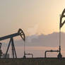 Oil pumps in a landscape at sunset