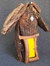 Yellow door on rustic fairy house