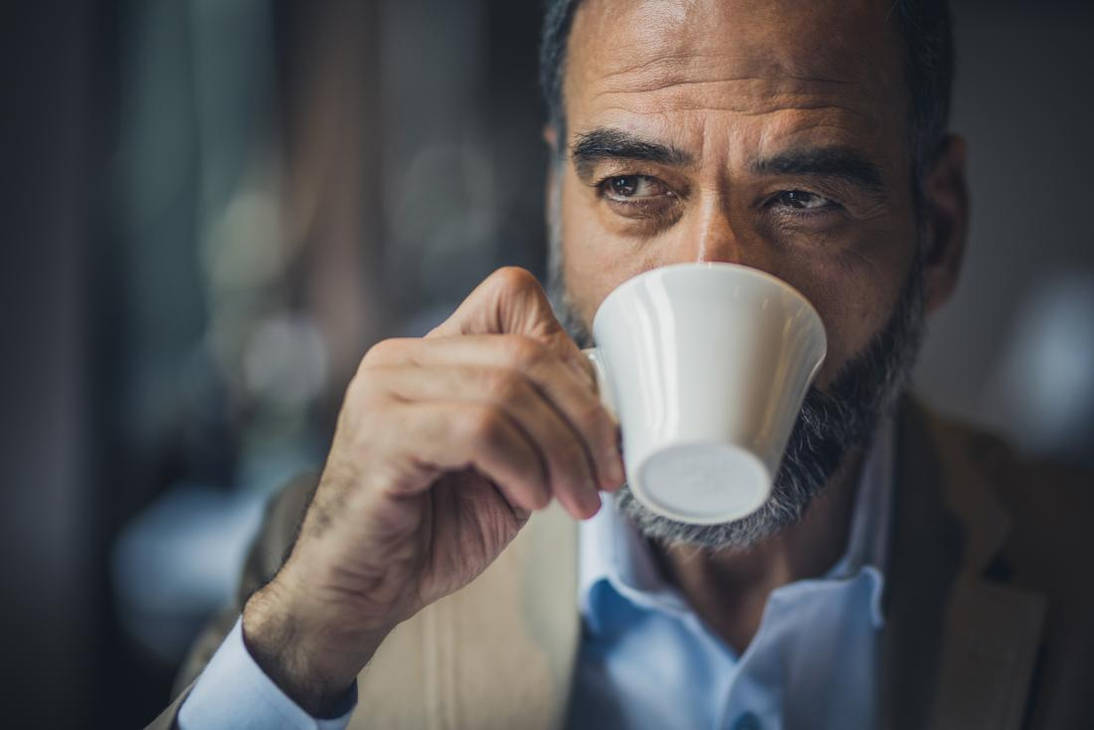 Почему турки пьют. Пить кофе. Мужчина пьет кофе. Грустный мужчина в кафе. Мужчина с кофе.