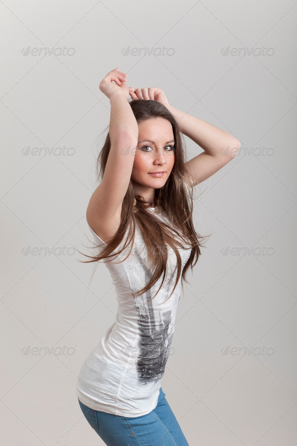 Young Girl Dancing with Her Hands in the Air