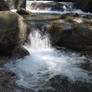 Water passing between rocks of brook