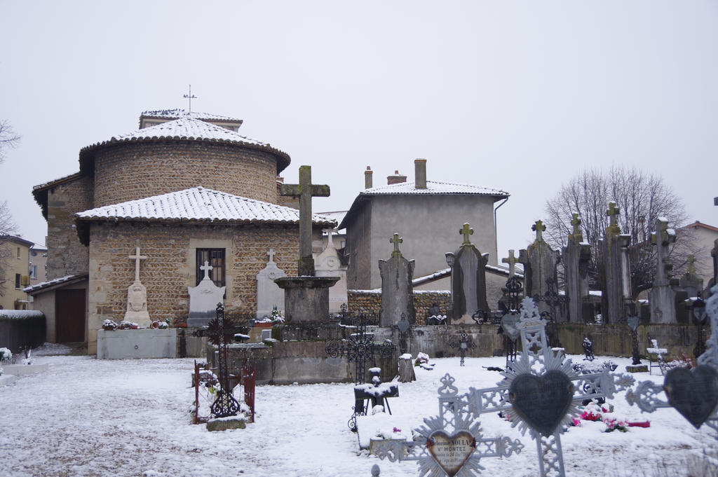 Darkscenery of snowy cemetery and old church