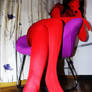 Zentai girl sitting in chair