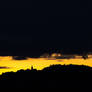 Yellow sunset over lonely Slovenian church