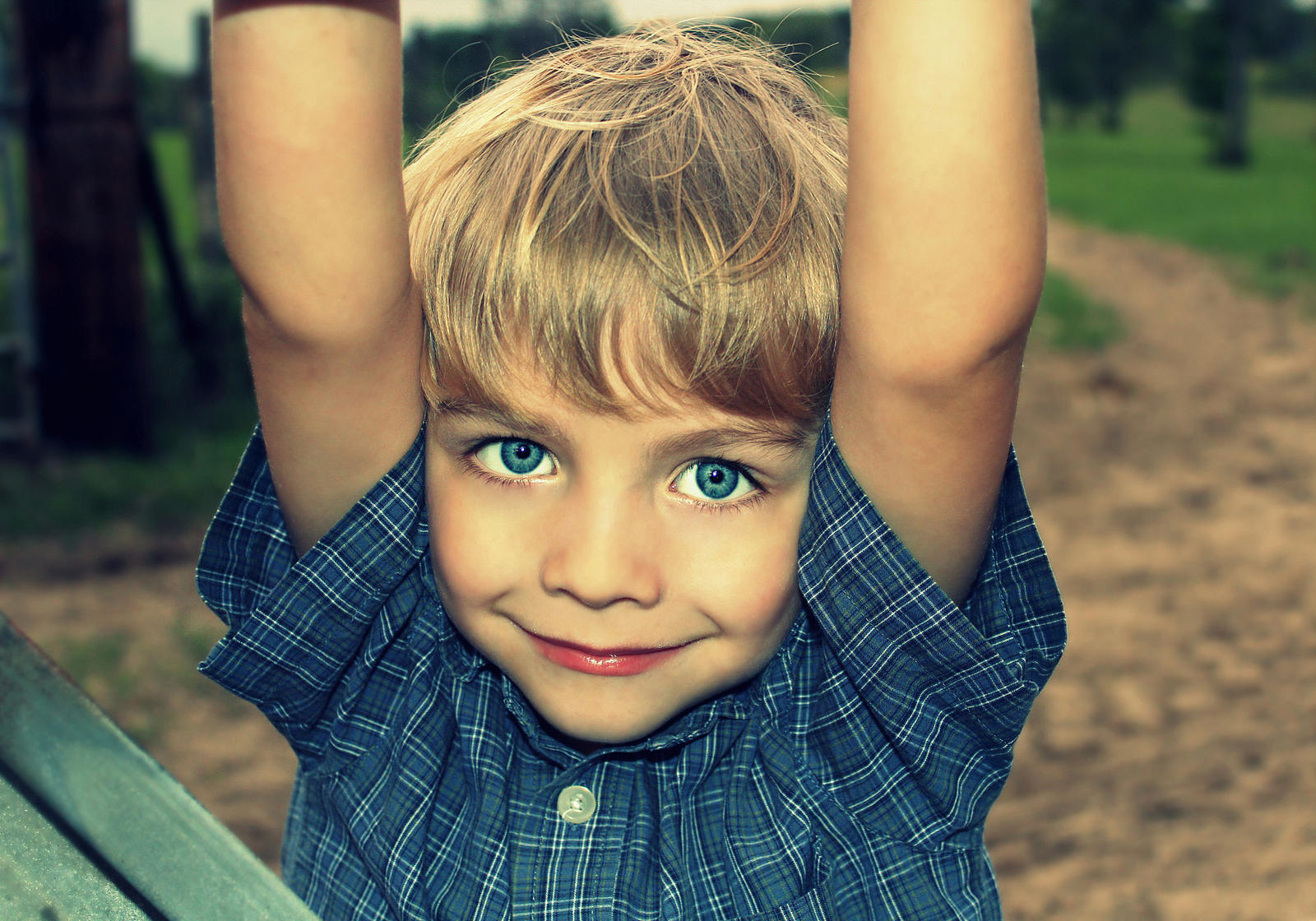 A happy little boy playing on a farm