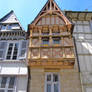 House with a stone bottom and a wooden top