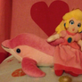 princess peach plush riding on pink dolphin plush