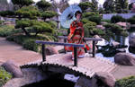 Red Kimono Lady with Blue Parasol over Bridge by AndySerrano