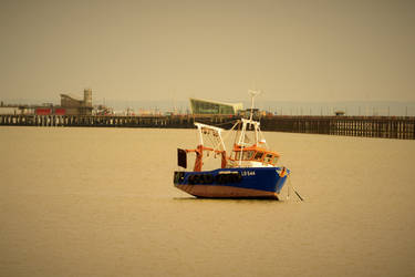 A Fishing Boat At Low Tide