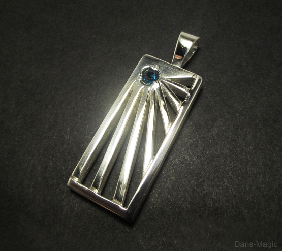 Blue topaz starburst pendant.